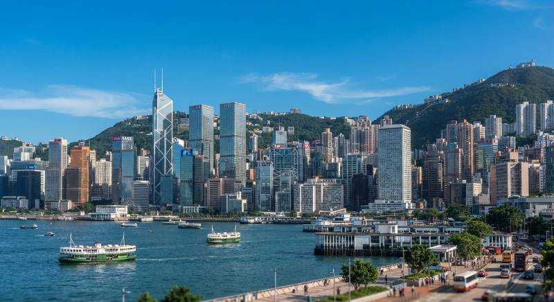 Modern Hong Kong financial district skyline with bank buildings under a clear sky